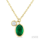 6x4 MM Oval Cut Emerald and 1/20 Ctw Bezel Set Round Cut Diamond Precious Pendant With Chain in 14K Yellow Gold
