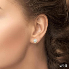 1/5 Ctw Petite Bezel Set Oval Shape Fusion Baguette and Round Cut Diamond Fashion Stud Earrings in 10K Yellow Gold